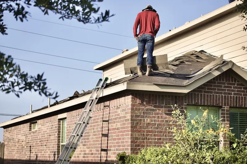 Professional roofer working on a residential roof in Vinings Estates